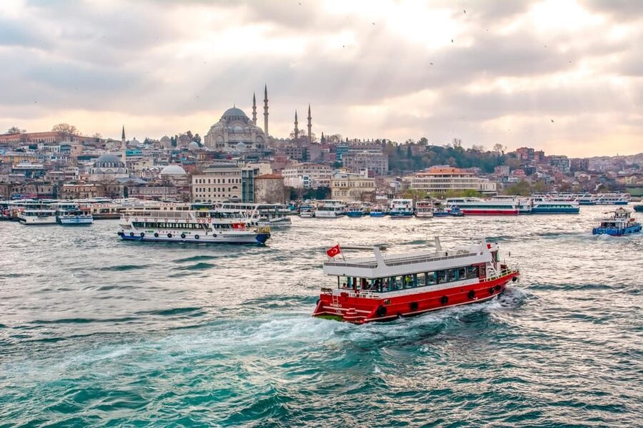 Istanbul: Bosphorus Strait Sightseeing Cruise & Audio Guide - Dolmabahçe Palace and the first turn along the shore